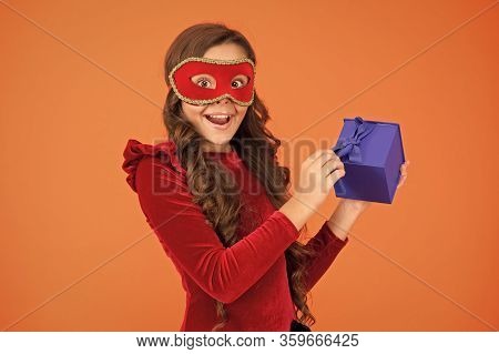 Winter Event And Entertainment. Secret Santa Gift Concept. Kid Wear Eye Mask. Girl In Mask Orange Ba