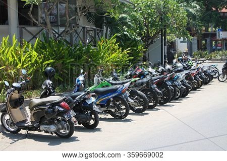 Bali, Seminyak - October 06, 2013: Many Motorbikes Are Parked In A Row On A Beautiful, Sunny, Green 