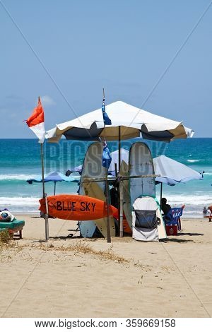 Bali, Indonesia, Seminyak - October 06, 2013: Surfboard Rental. There Are Umbrellas And Sun Loungers