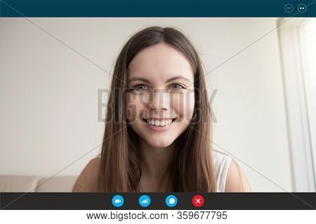 Young Woman Looks At Webcam Communicating With Boyfriend By Videocall
