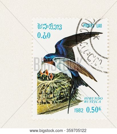 Seattle Washington - April 3, 2020: Close Up Of Laos Stamp With  Hirundo Rustica, Aka Barn Swallow. 