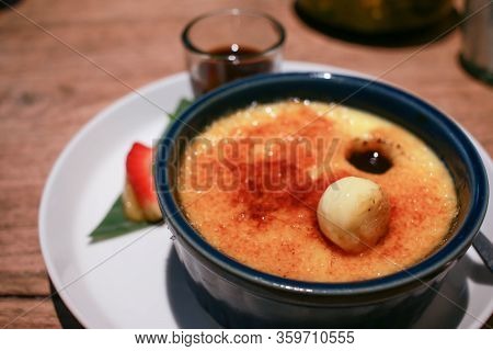 Close Up Image Of Vanilla Crème Brûlée On A White Plate.