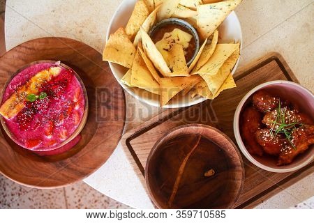 Top View Image Of Dragon Fruit Yogurt Smoothie Bowl With Banana Slice On Top, Nachos, Spicy Chicken 