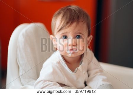 Funny Cute Adorable Baby Eating Yogurt In The Kitchen
