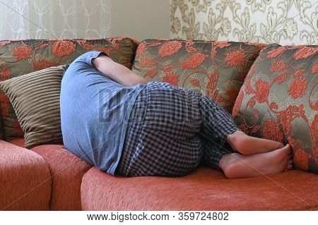 Man Is Lying On The Couch In Depression. Lying On The Couch In The Fetal Position.