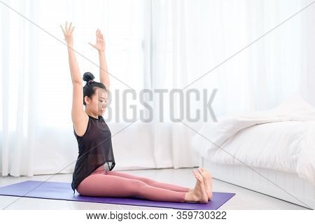Young Woman Do Yoga In A Bed Room