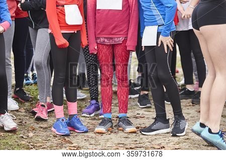Young Female Atheletes Ready To Run. Race Start Line. Athleticism