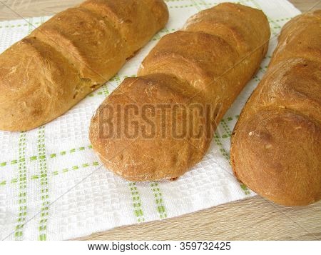 Freshly Baked Spelt Baguette On A Dishtowel