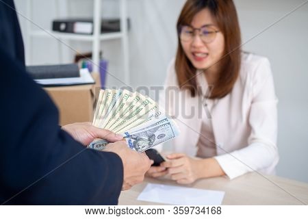 General Manager Presenting An Envelope With Premium Or Bonus Cash To Female Official. Boss Congratul