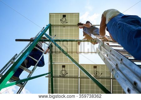 Mounters Holding, Installing Innovative Solar Panel On Metallic Construction. Environment Friendly, 