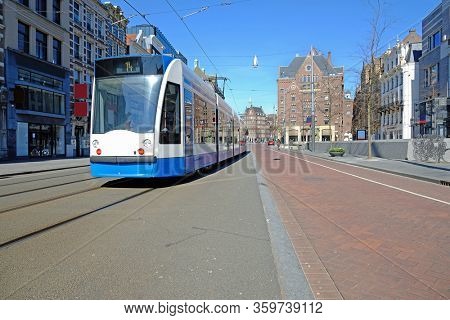 Tram driving on an empty Rokin in Amsterdam the Netherlands during the corona crisis