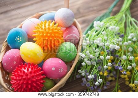 Virus Model Of Coronavirus Disease Covid-19 With Colorful Easter Eggs In Basket With Flowers On A Wo