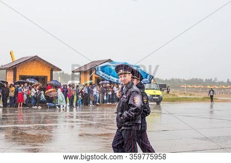 Kogalym, Russia - 06.16.2018: Sabantui Celebration Event On A Rainy Day, Police Officers Guard The T