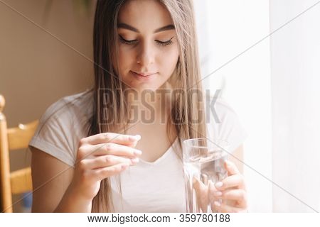 Portrait Of Woman Eating Pills. Female At Home On Quarantine. Self Isolation. Helthy Woman Take Vita