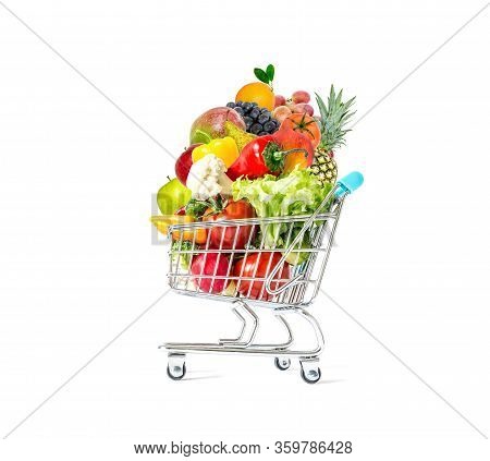 Fresh Vegetables And Fruits In A Crowded Shopping Cart Isolated On A White Background. Mountain Of F