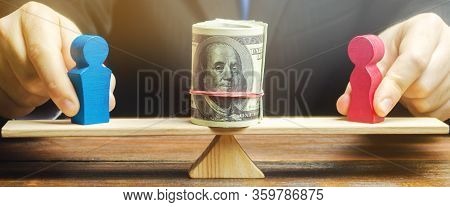 The Businessman Puts The Figure Of A Man And A Woman On The Scales With Money. Concept Of Gender Pay