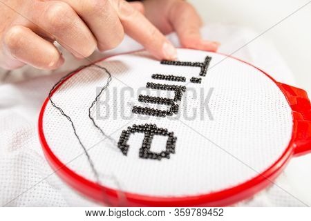 Conceptual Image Of Time. Girl Embroidered The Word Beads, Time On A White Background.