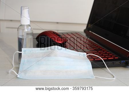 The Office Is Quarantined, Work From Home . Mask And Gel Potection Coronavirus On Laptop. Stay Home 