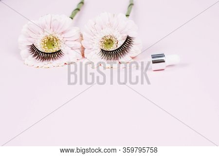 Flowers In The Form Of Human Eyes With Eyelashes Next To A Pipette With Moisturizing Serum For The S