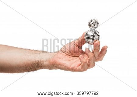 Male Hands Hold Silver Balls Similar To A Virus. The Background Is Isolated.