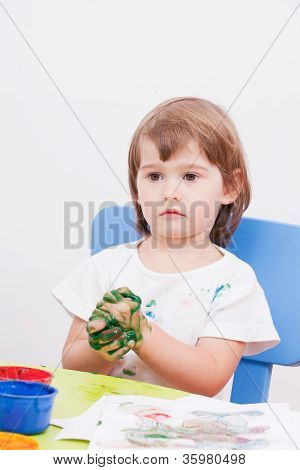 bambina disegna vernice seduto al tavolo