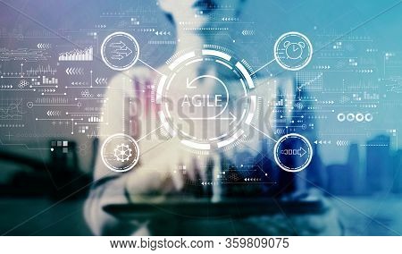 Agile Concept With Businesswoman Using A Tablet On A City Background