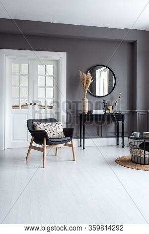 Modern Living Room Interior With Stucco Molding On The Walls With A Scandinavian-style Armchair, Con