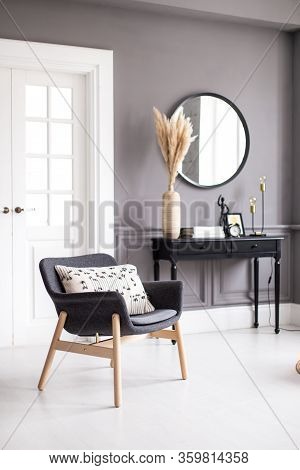 Modern Living Room Interior With Stucco Molding On The Walls With A Scandinavian-style Armchair, Con