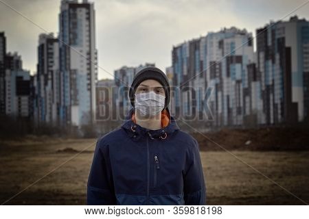 Teen Wearing A Medical Mask Against The Background Of A City Against Quarantine