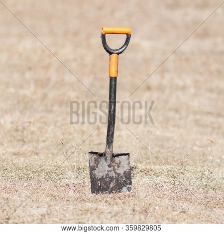 A Shovel Stuck In The Ground. Close Up.