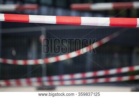 Barrier Tapes And Fence In Front Of A Building Or Hospital Because Of Quarantine For Covid-19 Or Cri