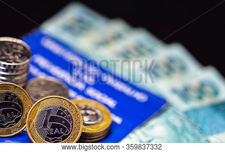 Old Work Card From Brazil, Old And Handled Document. Beside Real Coins, Brazilian Money. Concept Of