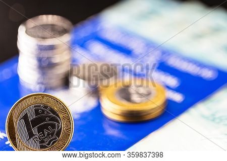 Old Work Card From Brazil, Old And Handled Document. Beside Real Coins, Brazilian Money. Concept Of