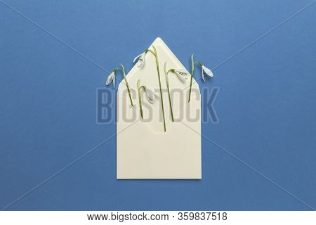 Fresh Beautiful Snowdrops Flowers In Envelope Isolated On Blue Background. Invitation On Wedding Or 