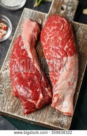 Raw Fresh Steak Sirloin Flap Served With Rosemary, Garlic And On Wooden Cutting Board. Black Angus B