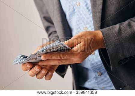 Closeup Of Hands Of A Man Who Remits Money.