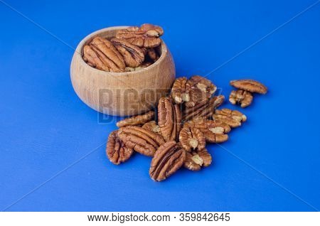 Pekan Nut Close-up On A Classic Blue Background.