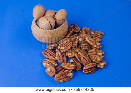 Pekan Nut Close-up On A Classic Blue Background.
