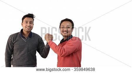 Two Men With Different Ethnicity With Hands Fisted Together Showing Sign Of Bonding And Unity In Whi