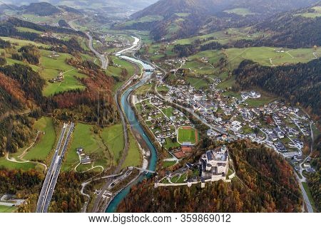 Aerial View Of Green Meadows With Villages And Forest In Austrian Alps Mountains.