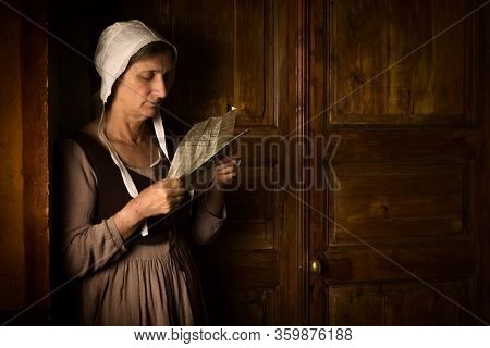 Portrait of a ature woman reading in an Old Master or Renaissance style