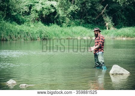 Bearded Man Catching Fish. Fishing Background. Senior Man Fishing. Angler Catching The Fish. Fisherm