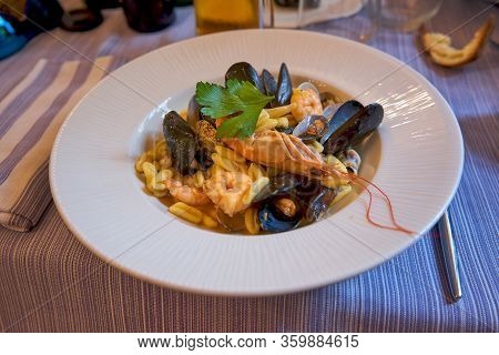 Cavaletti Pasta With Seafood And Mussels Served In A Traditional Italian Restaurant