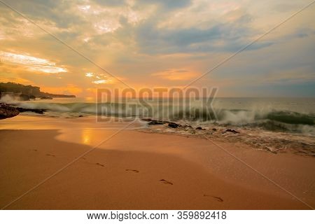 Amazing Seascape. Sunset Time At The Beach. Beach Background With Footprints In The Sand. Sunlight R