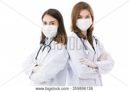 Two Female Doctors Wearing Surgical Protective Hygiene Mask Standing Together Isolated On White Back