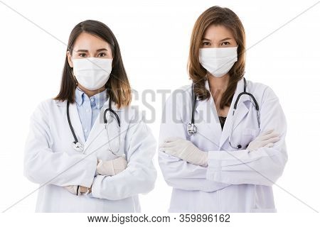 Two Female Doctors Wearing Surgical Protective Hygiene Mask Standing Together Isolated On White Back