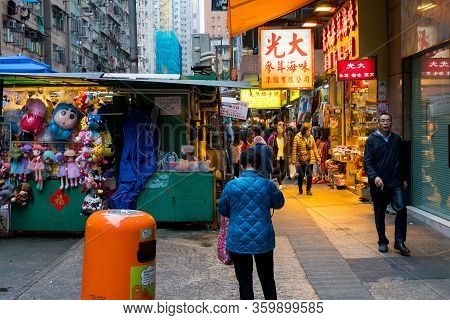 Hong Kong,march 24,2019:people Among The Classic Markets In The Narrow And Crowded Streets Of Hong K