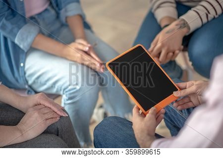 Close Up Picture Of People Sitting In A Circle
