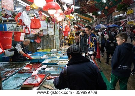 Hong Kong,march 24,2019:people Among The Classic Markets In The Narrow And Crowded Streets Of Hong K