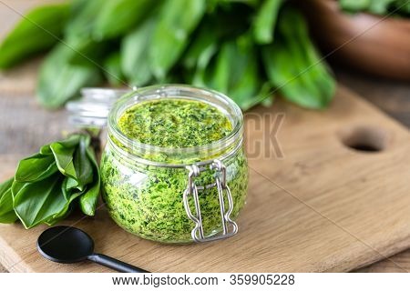 Wild Leek Pesto With Olive Oil And Parmesan Cheese In A Glass Jar On A Wooden Table. Useful Properti